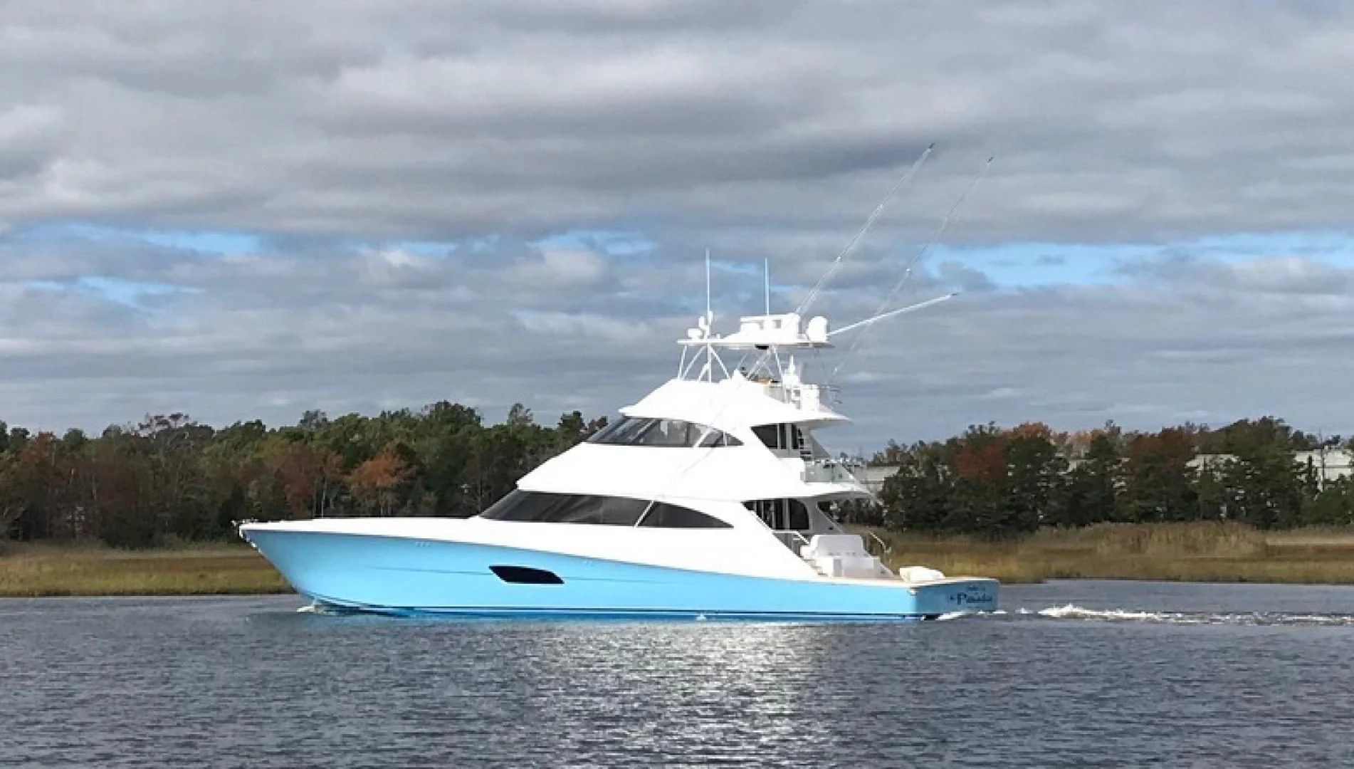 a white yacht on the water aboard AFTER MIDNIGHT Yacht for Sale