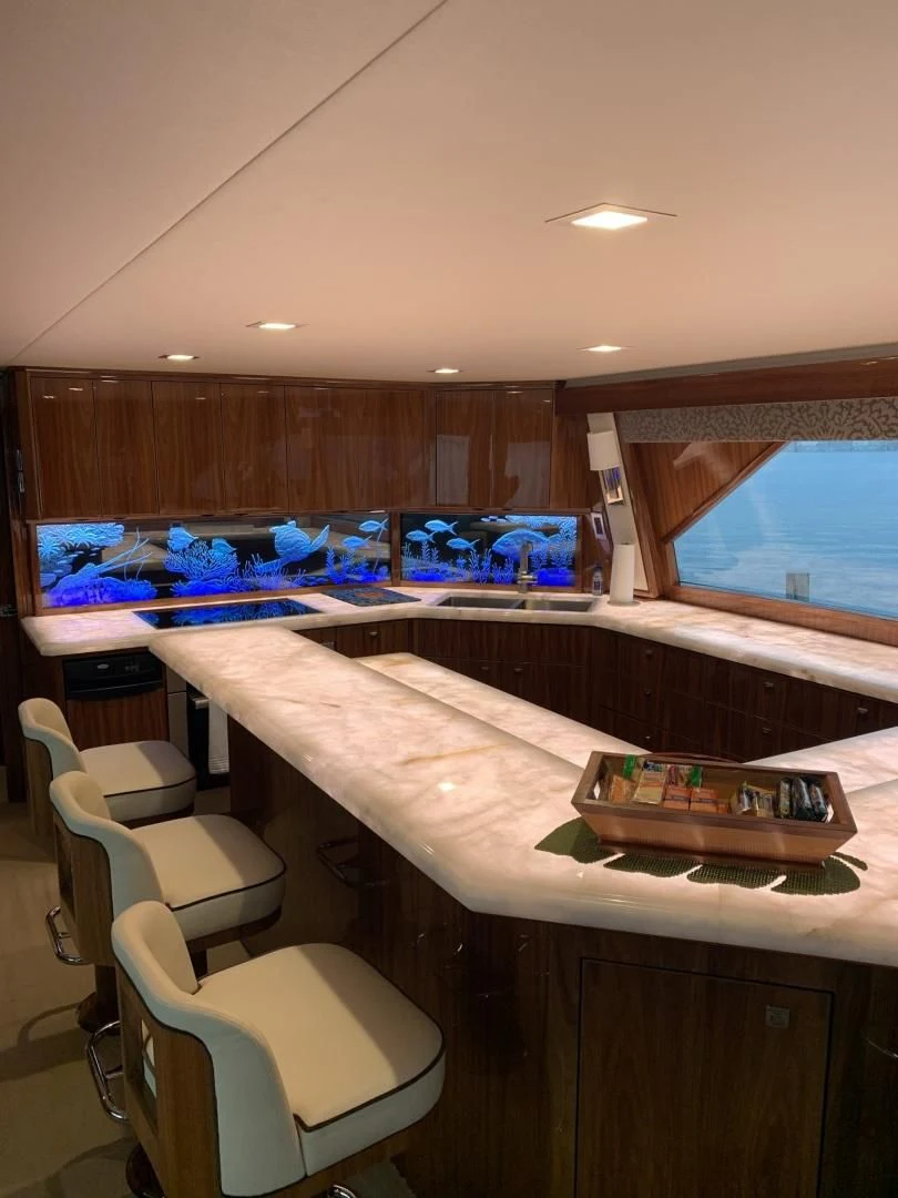 a room with a table and chairs aboard AFTER MIDNIGHT Yacht for Sale