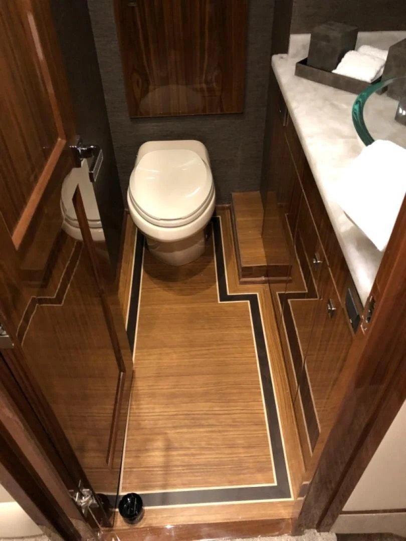 a bathroom with a wood floor aboard AFTER MIDNIGHT Yacht for Sale