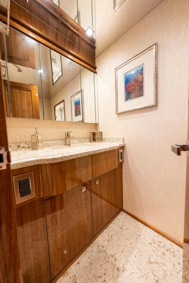 a bathroom with a large mirror aboard AFTER MIDNIGHT Yacht for Sale
