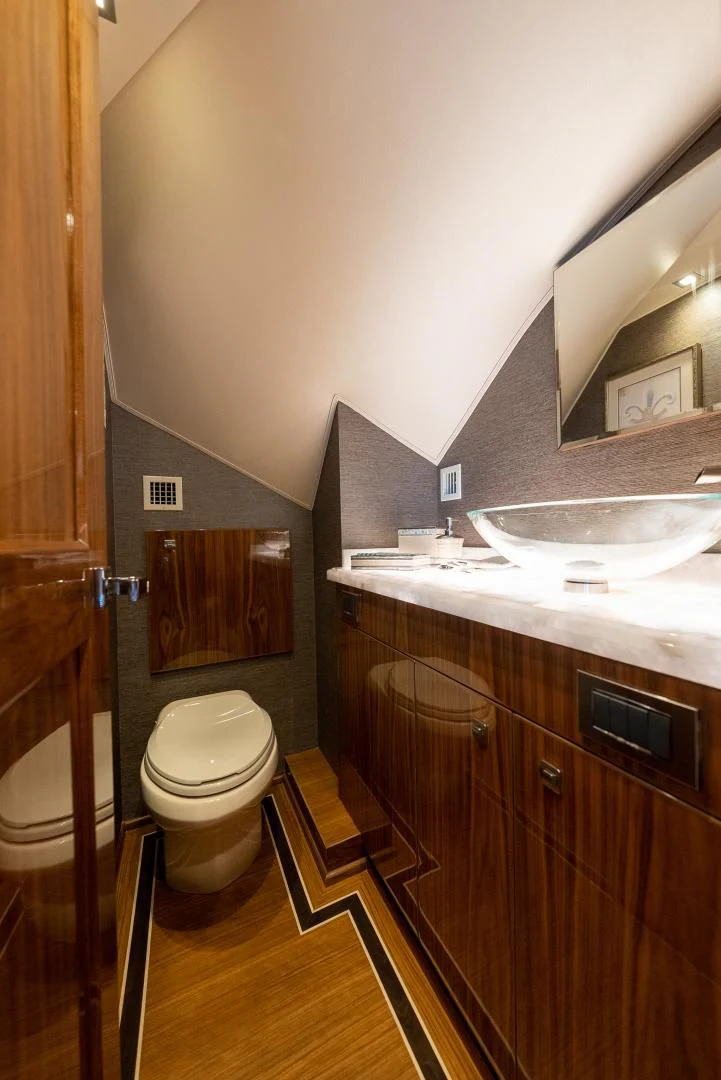 a bathroom with a sink and toilet aboard AFTER MIDNIGHT Yacht for Sale