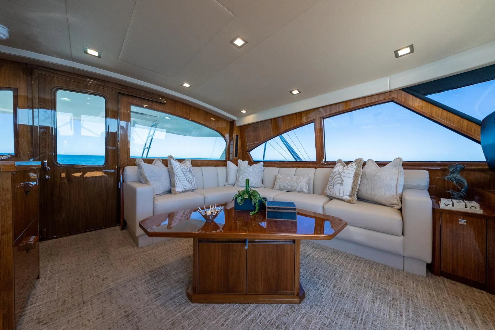 a living room with a couch and a coffee table aboard AFTER MIDNIGHT Yacht for Sale