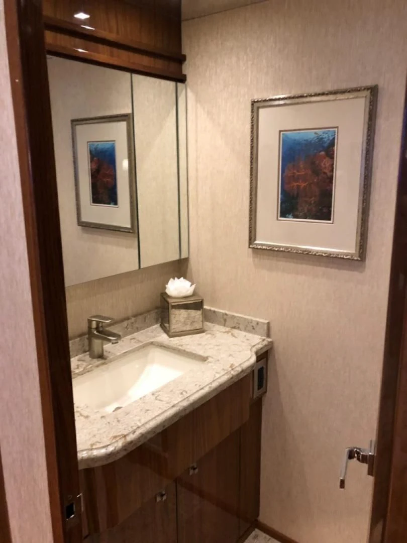 a bathroom with a mirror and a sink aboard AFTER MIDNIGHT Yacht for Sale