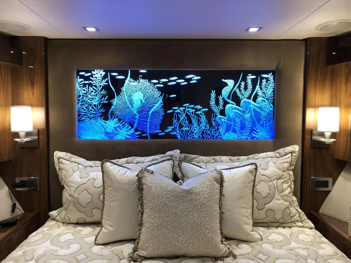 a large fish tank above a bed aboard AFTER MIDNIGHT Yacht for Sale