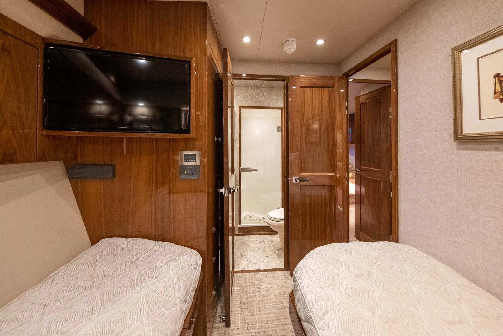 a bedroom with a bed and a television aboard AFTER MIDNIGHT Yacht for Sale