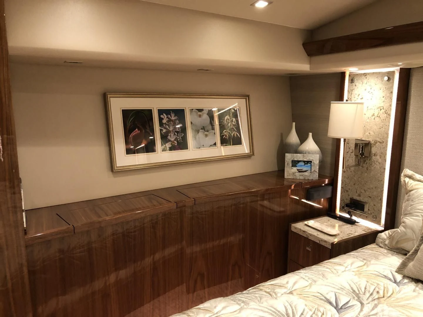 a bed with a painting on the wall aboard AFTER MIDNIGHT Yacht for Sale