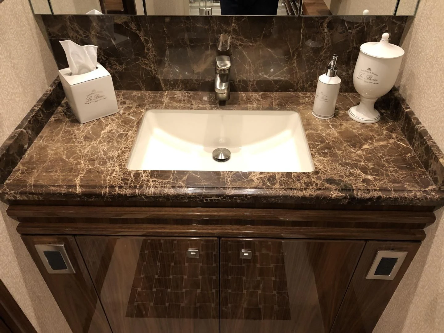 a bathroom sink with a mirror aboard AFTER MIDNIGHT Yacht for Sale