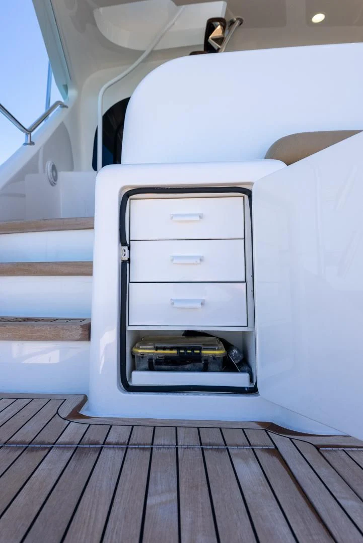 a white car with a door open aboard AFTER MIDNIGHT Yacht for Sale