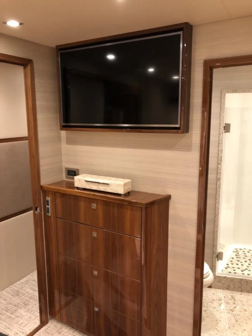a tv on a cabinet aboard AFTER MIDNIGHT Yacht for Sale