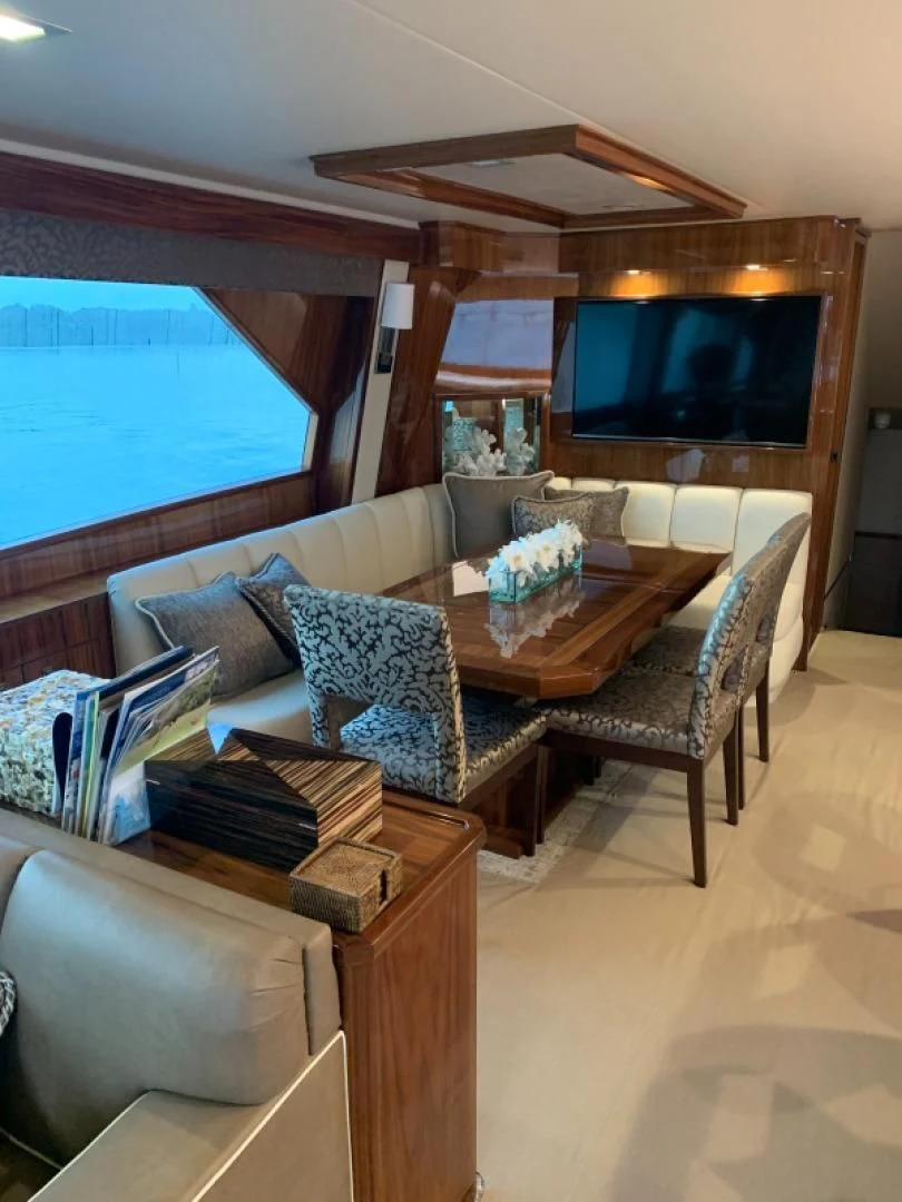 a living room with a couch and a tv aboard AFTER MIDNIGHT Yacht for Sale