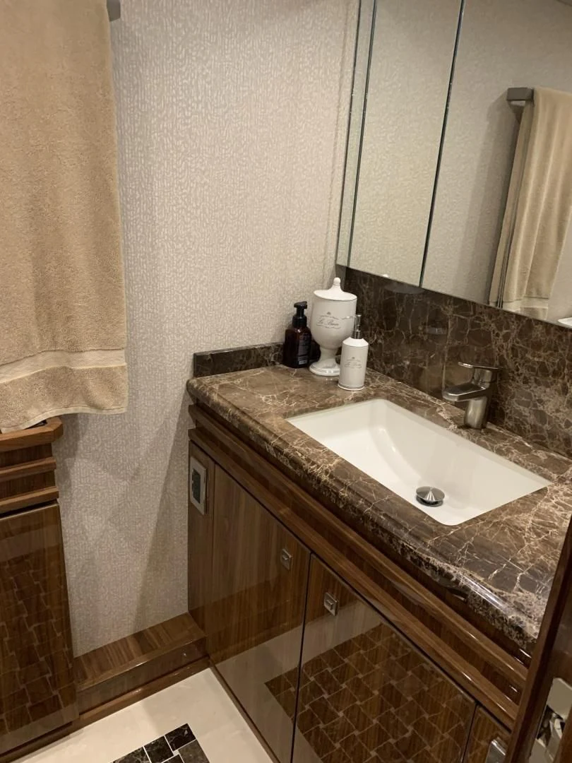 a bathroom with a sink and a mirror aboard AFTER MIDNIGHT Yacht for Sale