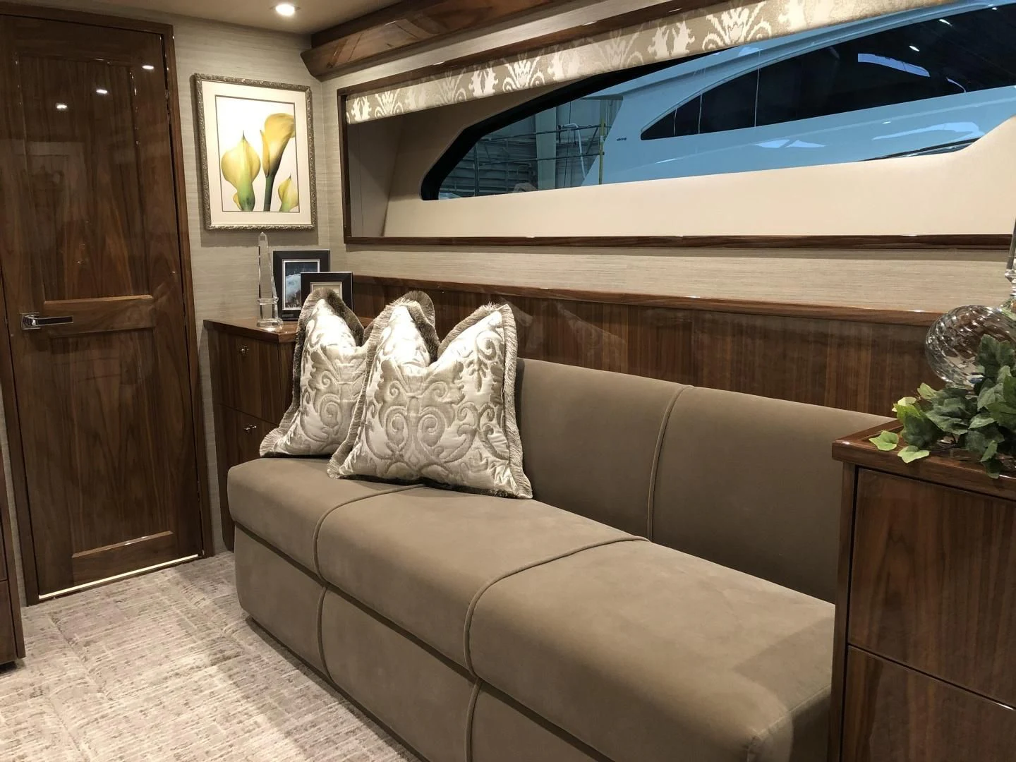a living room with a couch and a television aboard AFTER MIDNIGHT Yacht for Sale