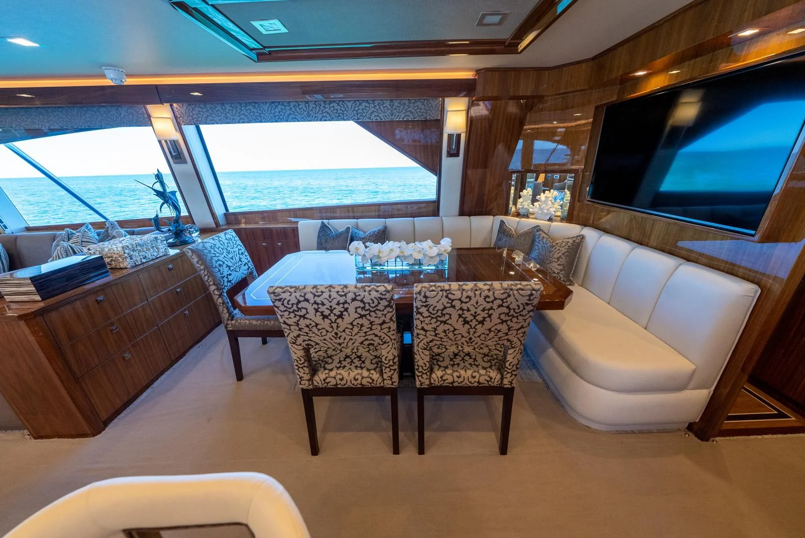 a room with a table and chairs aboard AFTER MIDNIGHT Yacht for Sale