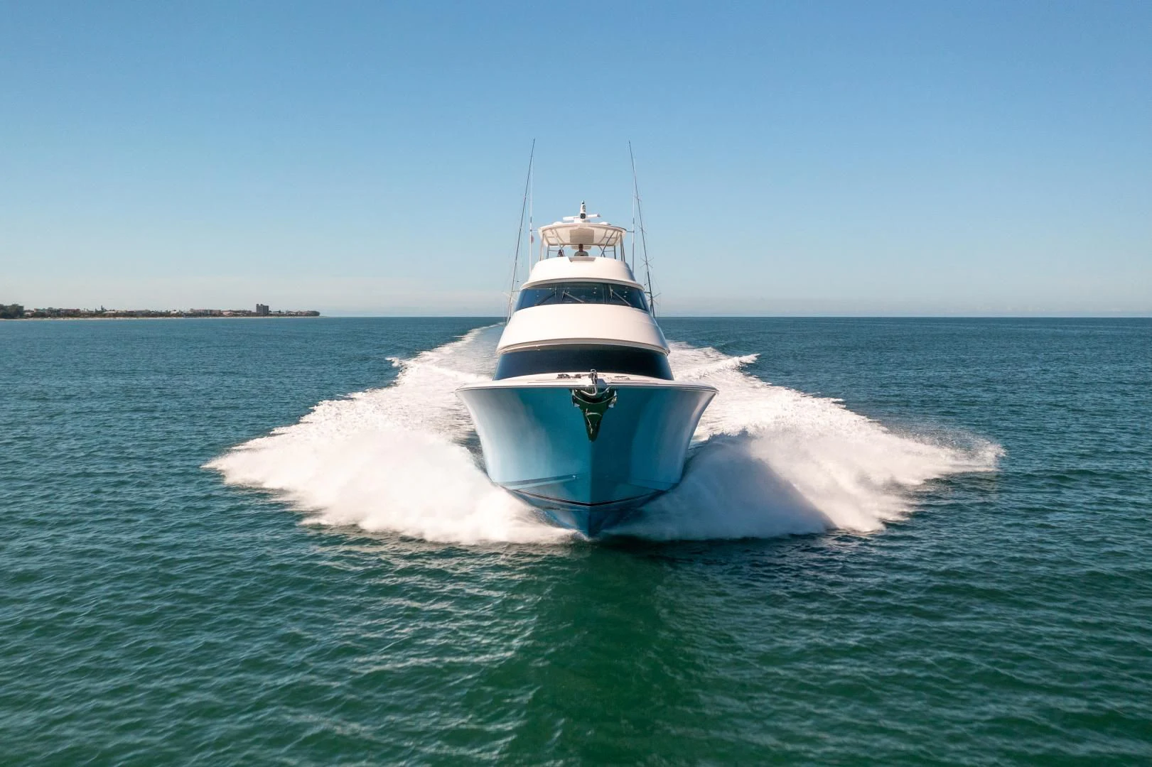 a white boat on the water aboard AFTER MIDNIGHT Yacht for Sale