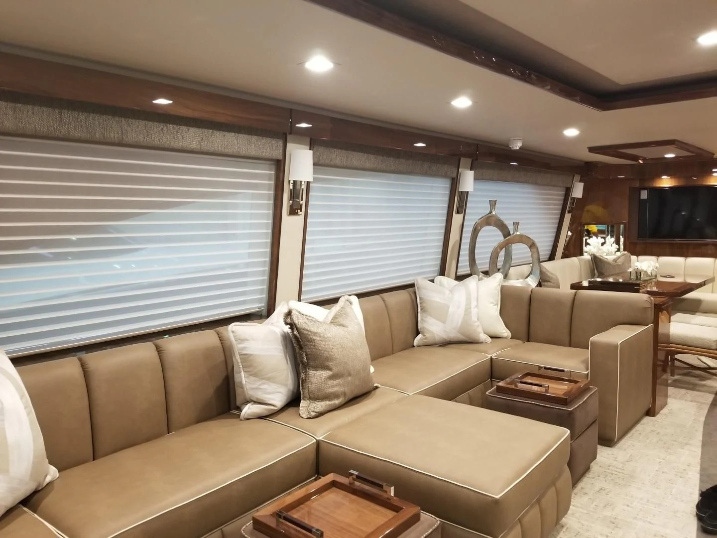a living room with a couch and a large window aboard AFTER MIDNIGHT Yacht for Sale