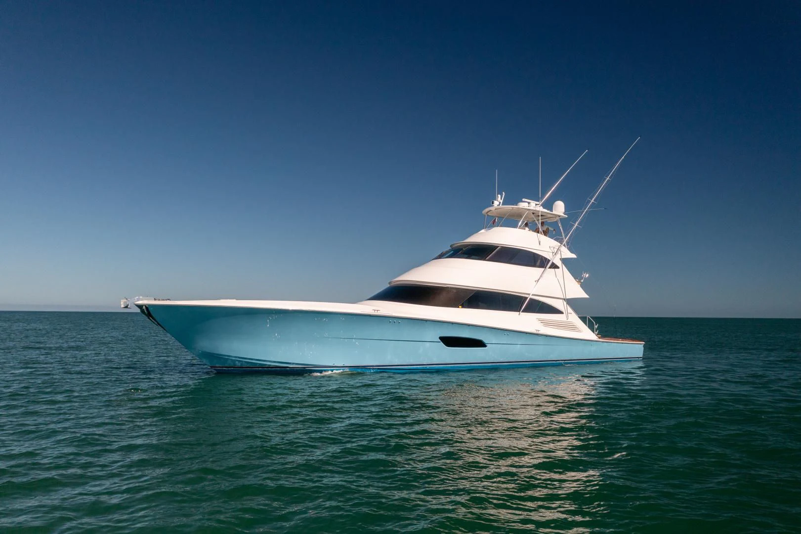 a white yacht in the water aboard AFTER MIDNIGHT Yacht for Sale