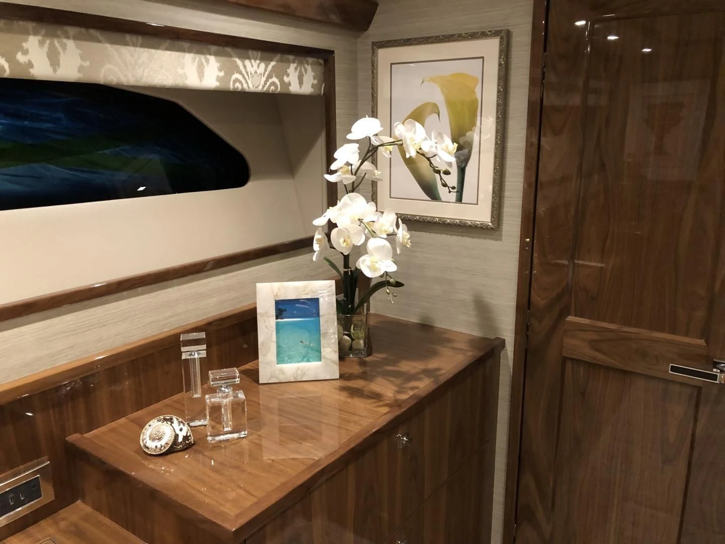 a desk with a laptop and a picture on it aboard AFTER MIDNIGHT Yacht for Sale