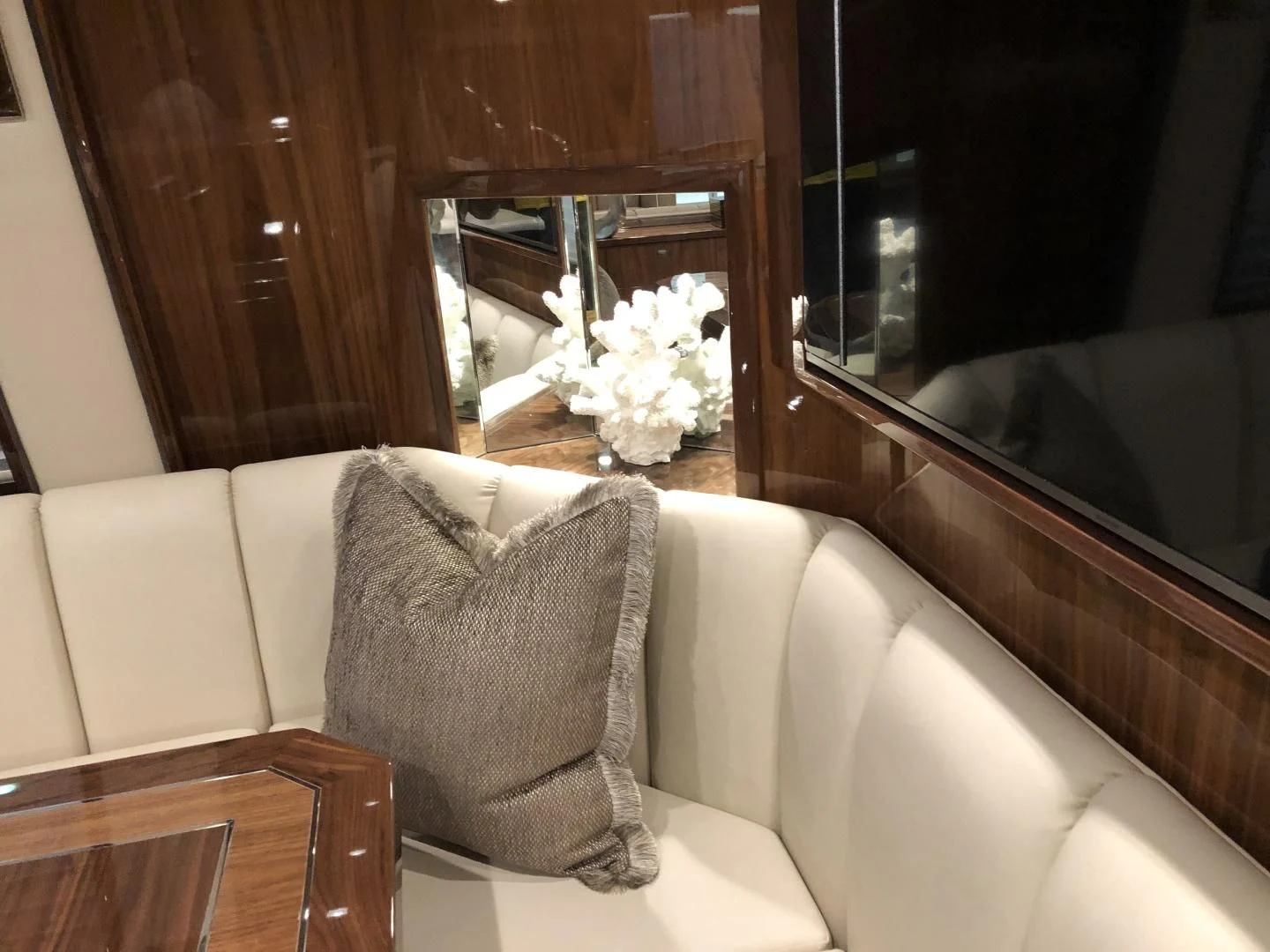 a couch with pillows and a mirror aboard AFTER MIDNIGHT Yacht for Sale