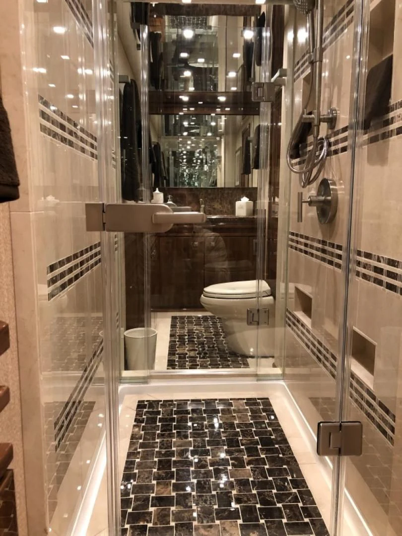 a bathroom with a glass shower aboard AFTER MIDNIGHT Yacht for Sale