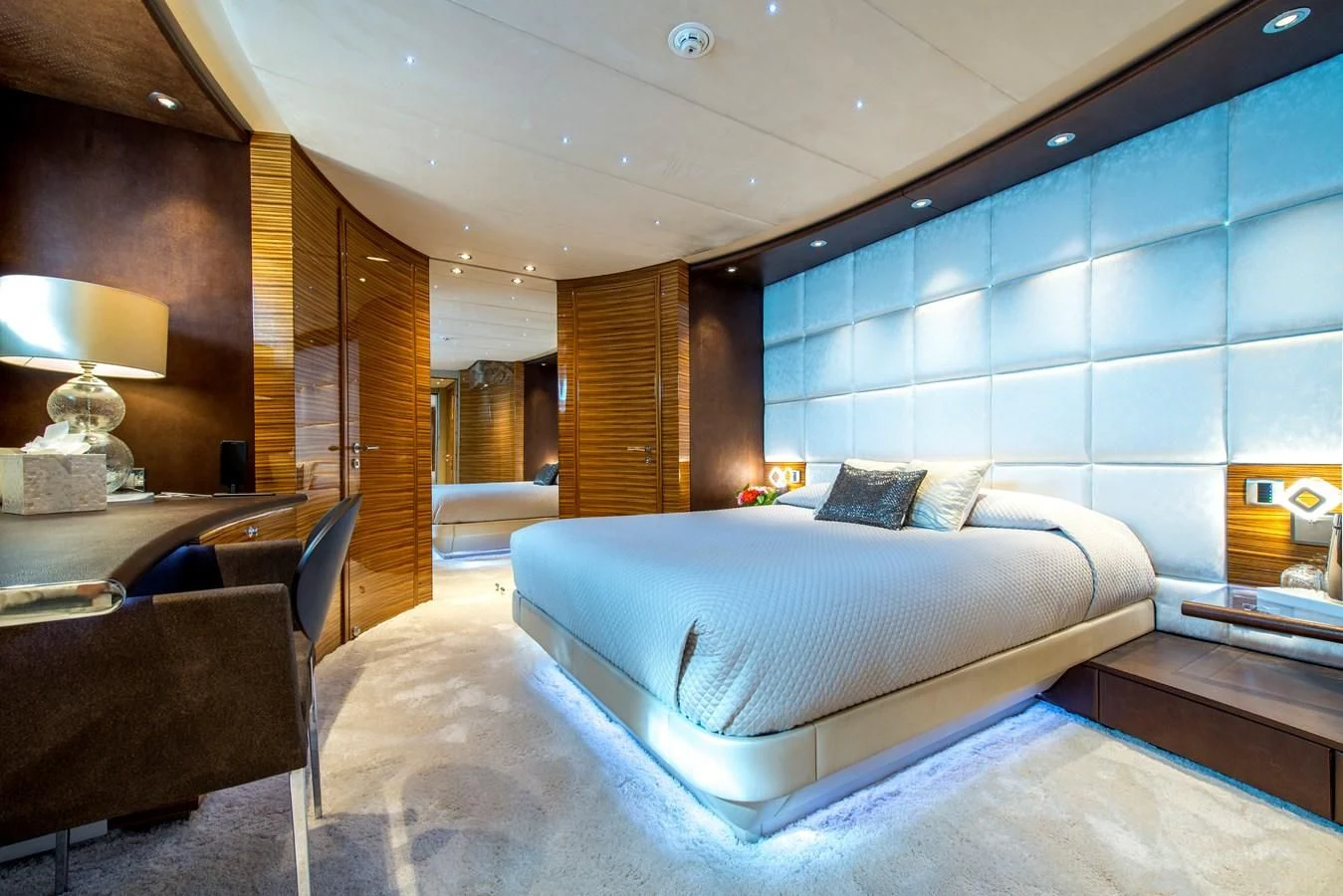 a room with a bed and a table aboard TIAMAT Yacht for Sale