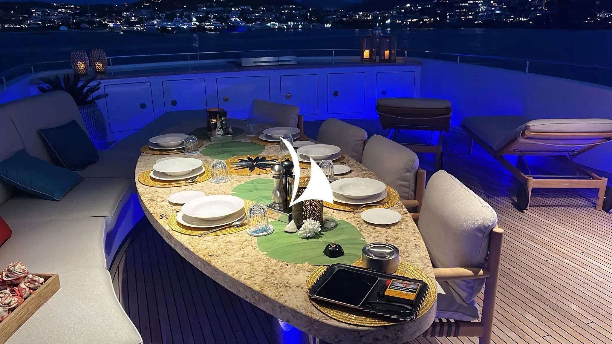 a table with plates and cups on it aboard TIAMAT Yacht for Sale