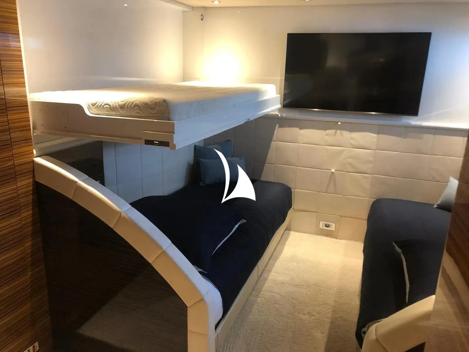 a room with a tv and a chair aboard TIAMAT Yacht for Sale