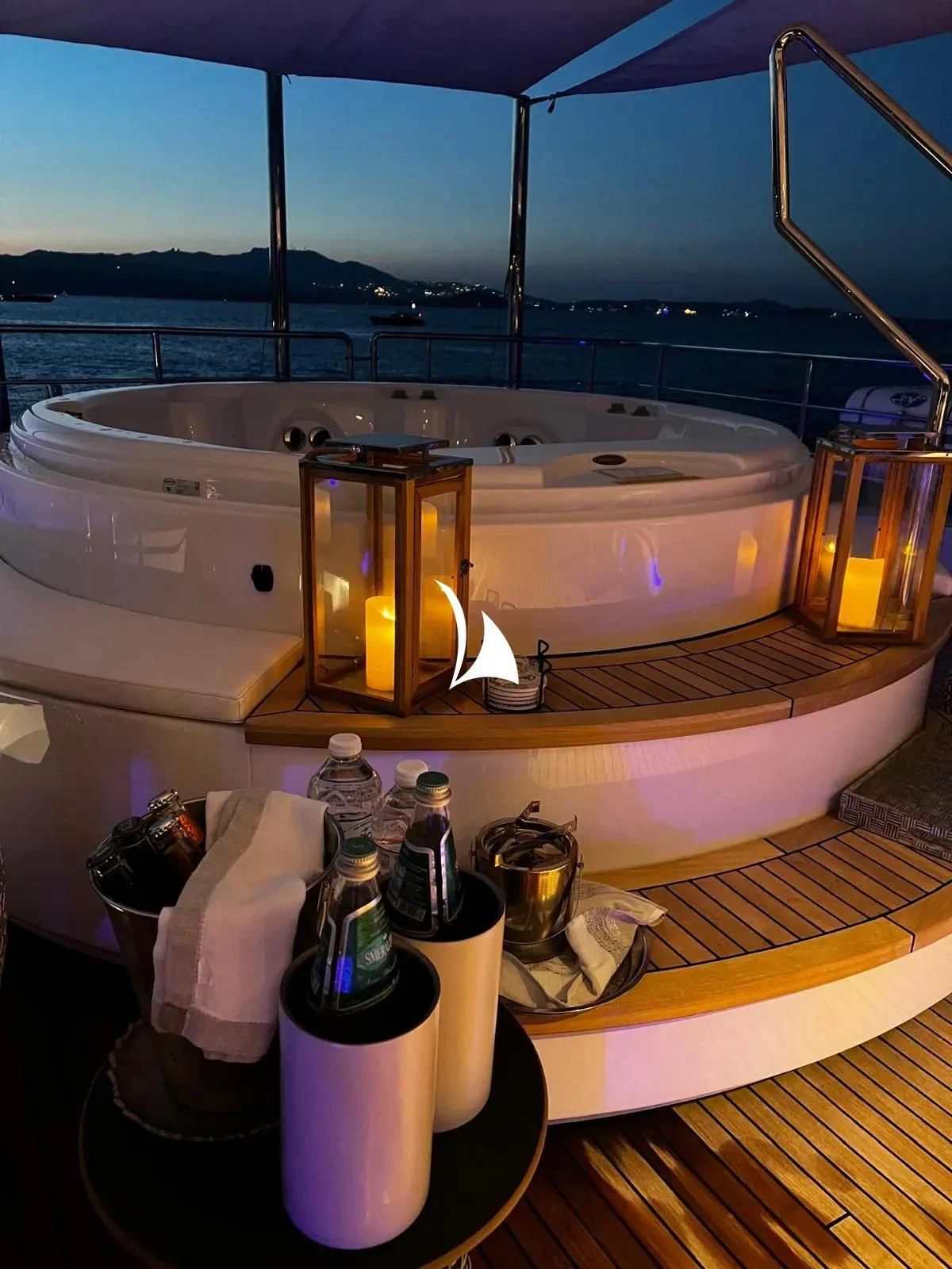 a large white sink with a glass top and a bottle of beer on a wooden surface aboard TIAMAT Yacht for Sale