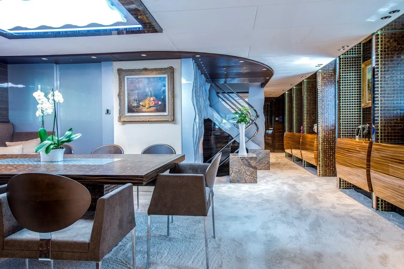 a room with a table chairs and a staircase aboard TIAMAT Yacht for Sale