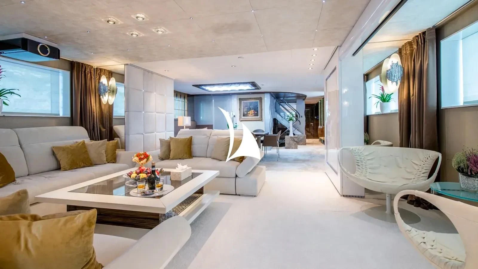 a living room with a white couch and a coffee table aboard TIAMAT Yacht for Sale