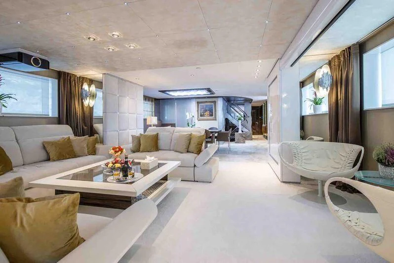 a living room with a white couch and a coffee table aboard TIAMAT Yacht for Sale