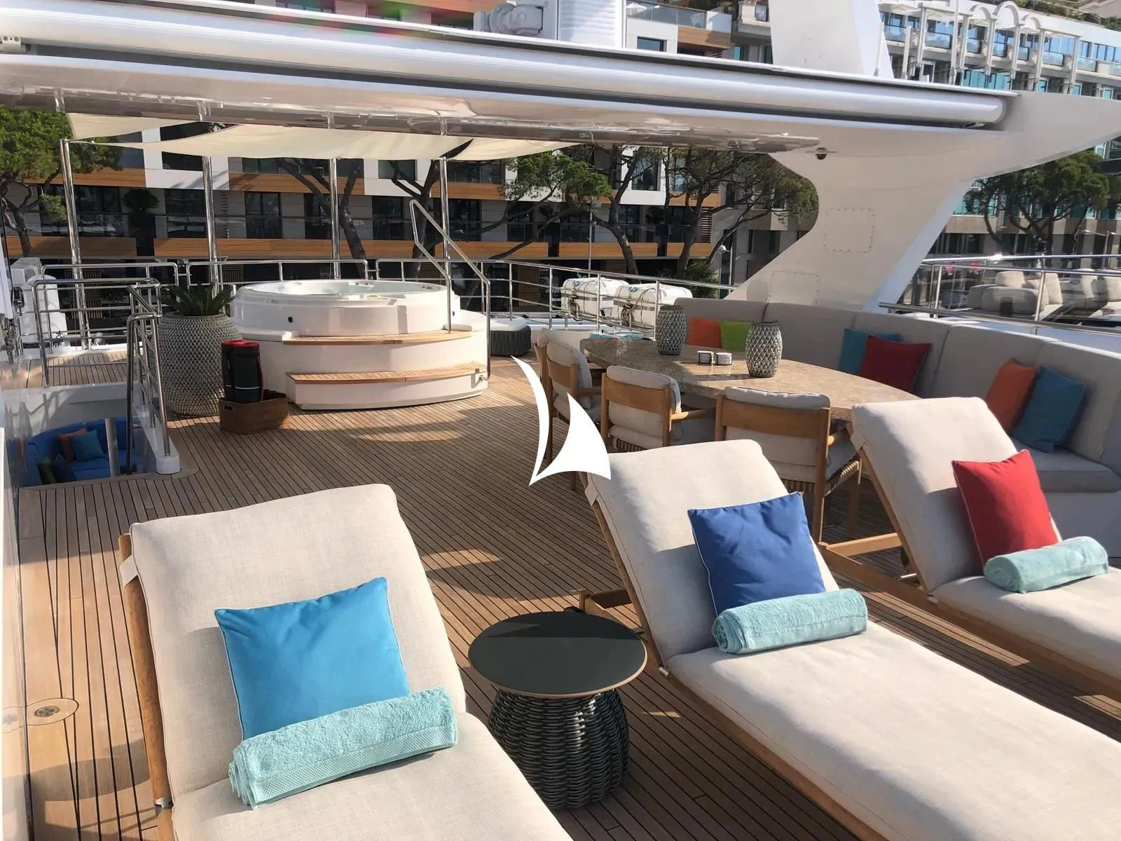a patio with a lounge chair and a pool aboard TIAMAT Yacht for Sale