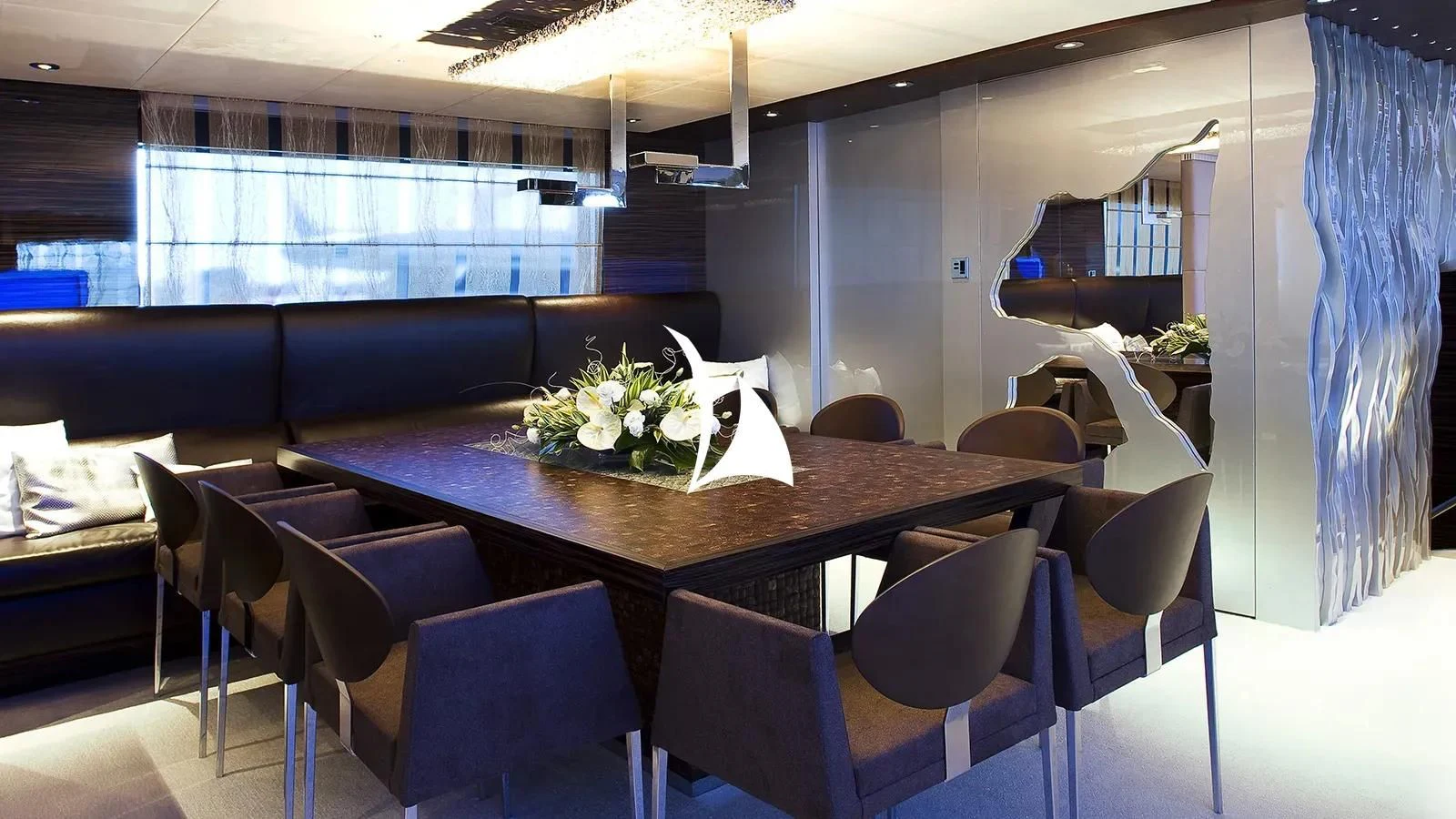 a room with a table and chairs aboard TIAMAT Yacht for Sale