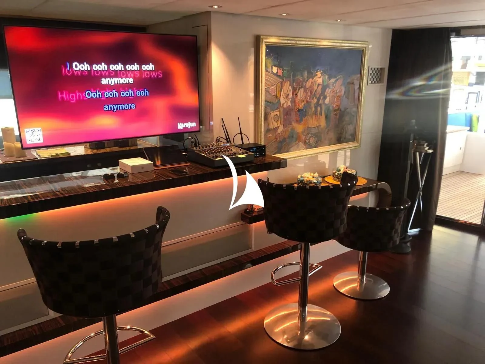 a room with a tv and a table with food on it aboard TIAMAT Yacht for Sale