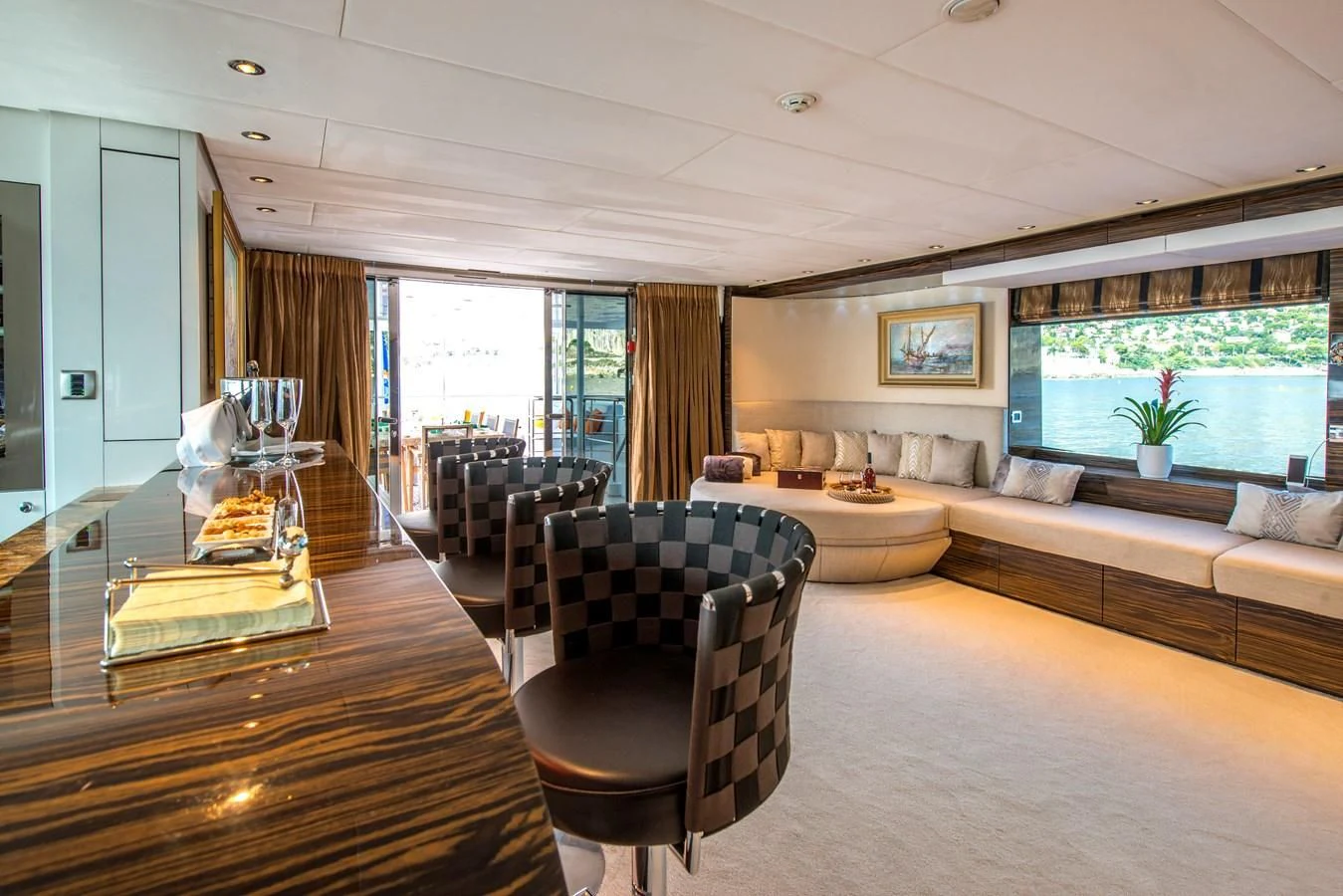a living room with a large window aboard TIAMAT Yacht for Sale