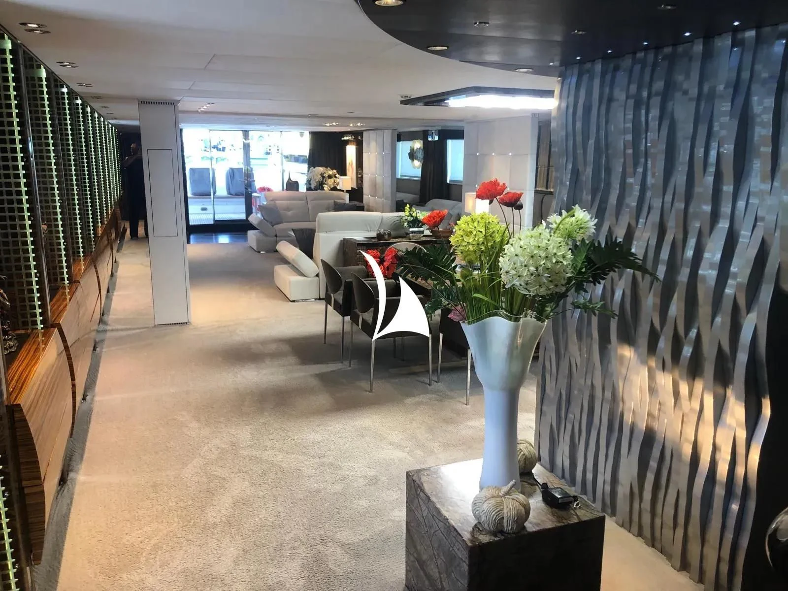 a vase of flowers sits on a table in a living room aboard TIAMAT Yacht for Sale