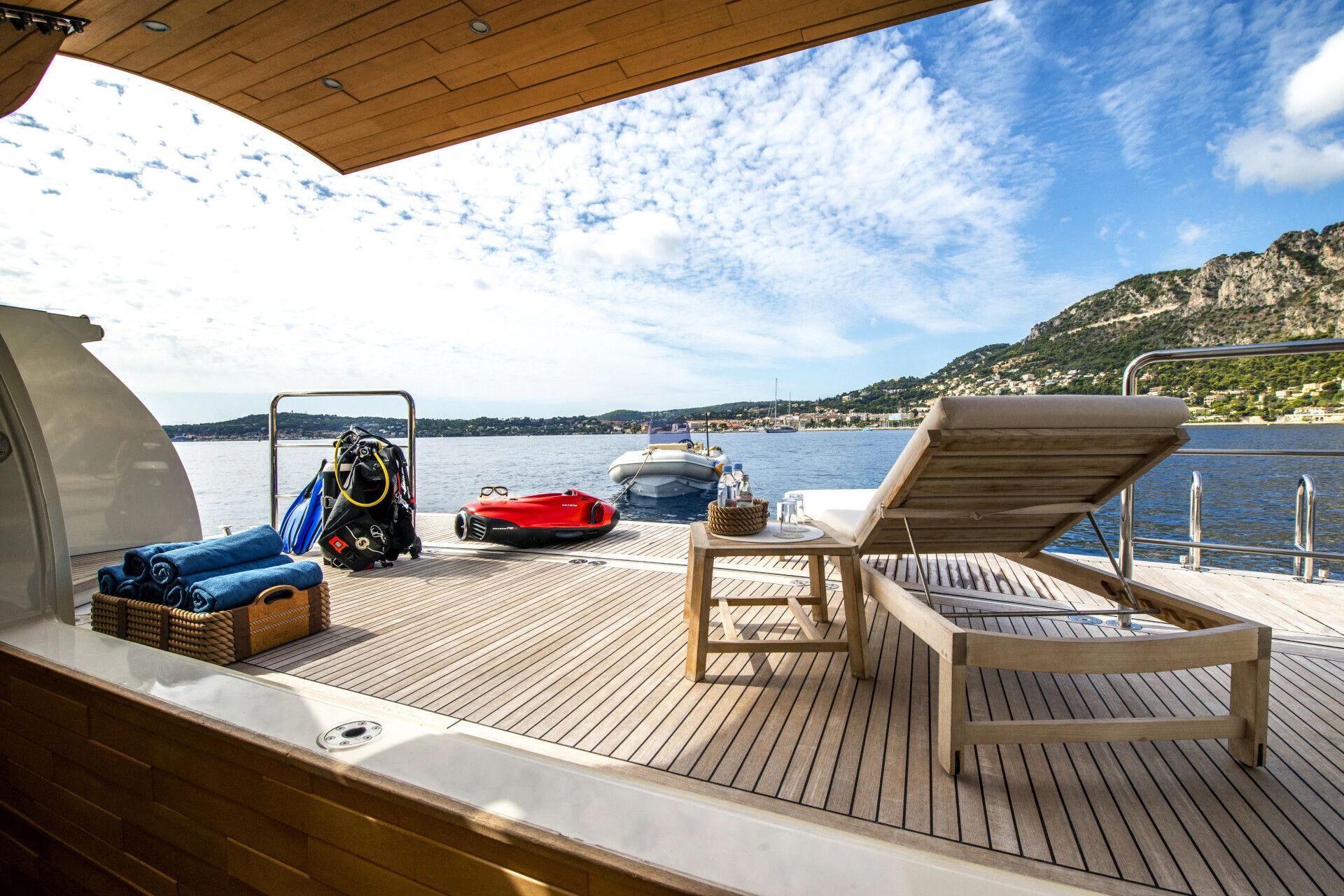 a deck with a boat and chairs on it aboard TIAMAT Yacht for Sale
