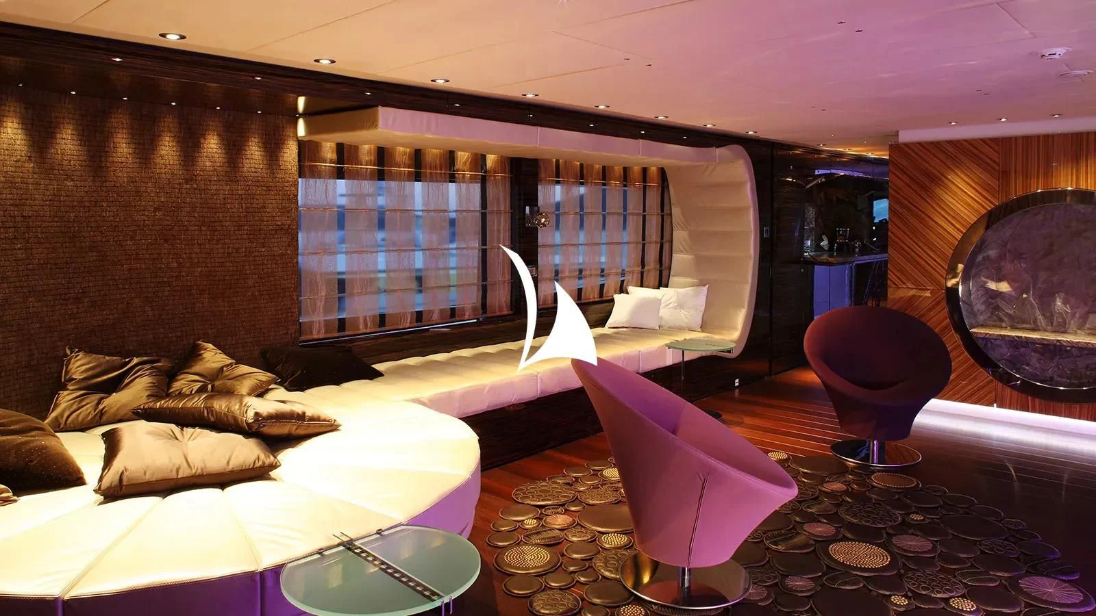 a room with a couch and a chair aboard TIAMAT Yacht for Sale