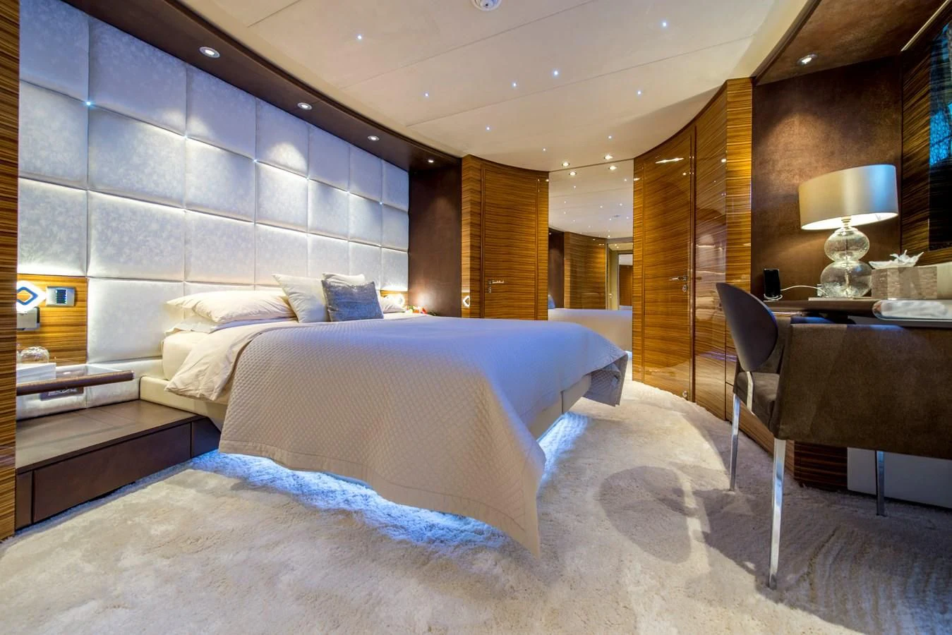 a bedroom with a bed and a desk aboard TIAMAT Yacht for Sale