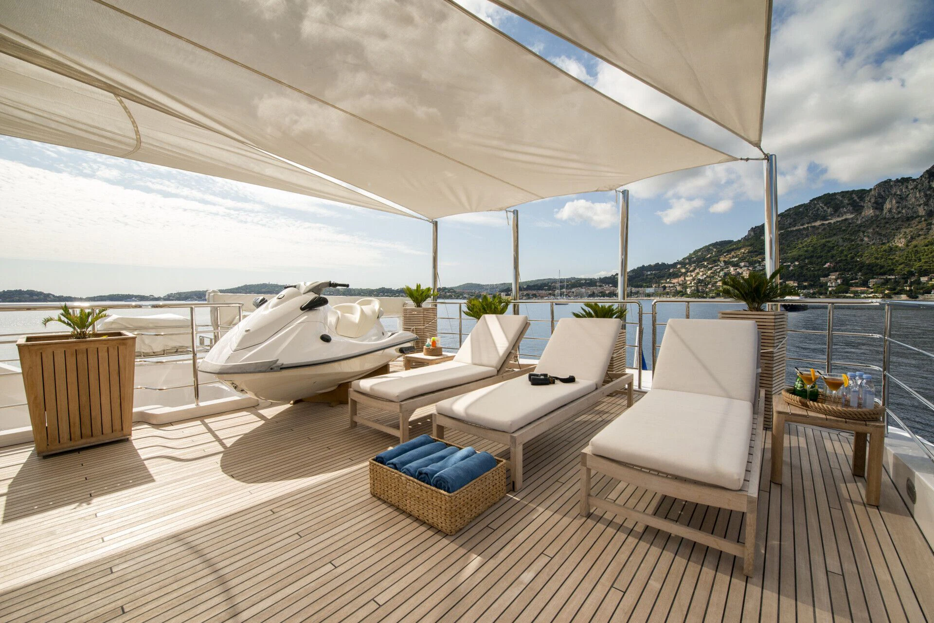 a room with a deck and chairs aboard TIAMAT Yacht for Sale