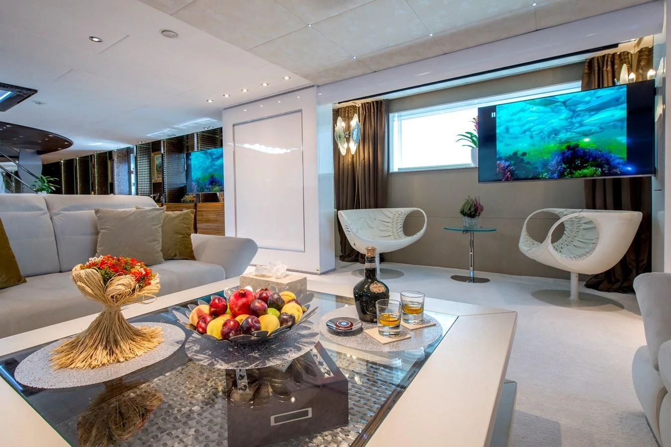 a living room with a large screen aboard TIAMAT Yacht for Sale