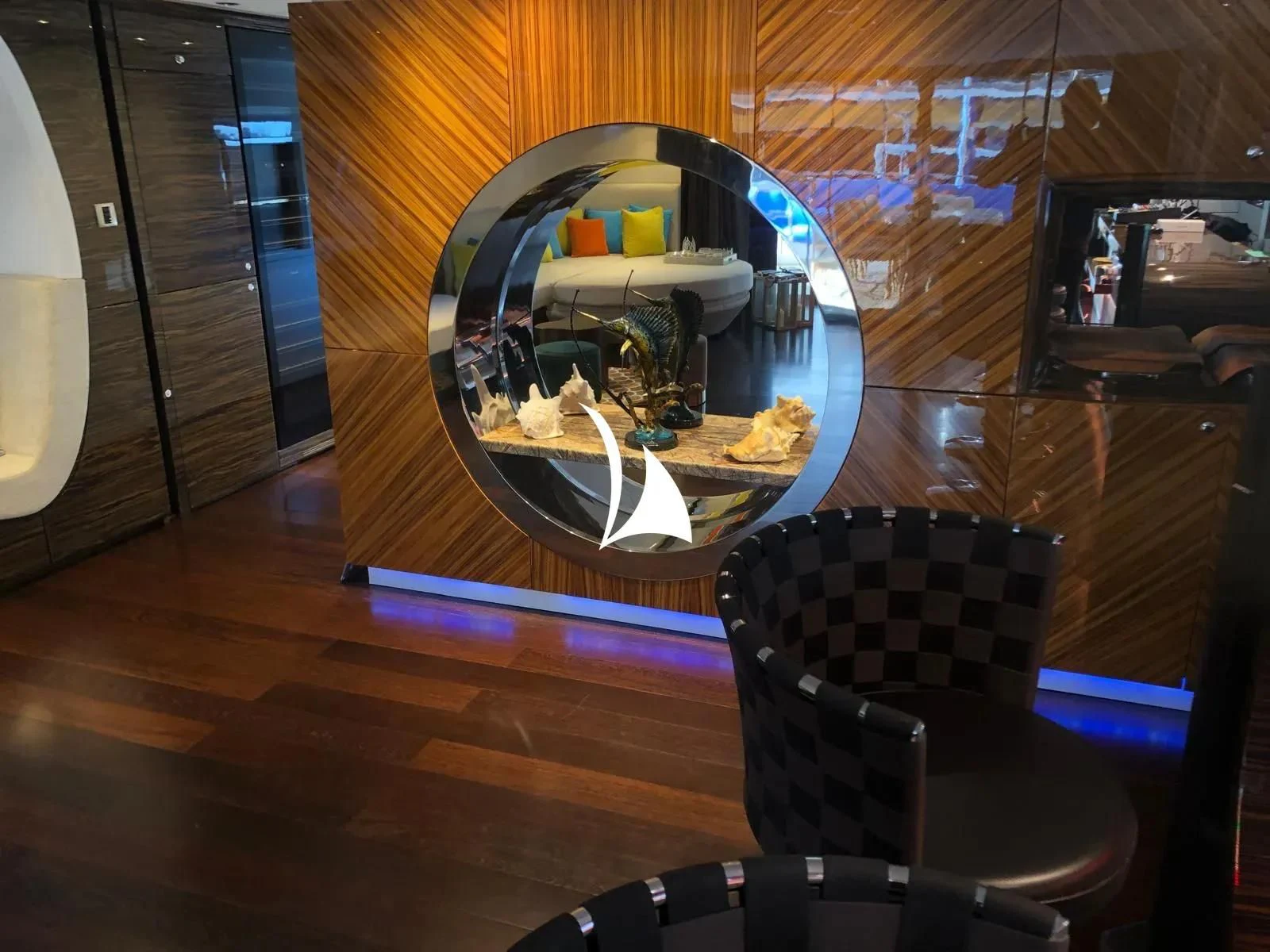 a room with a chair and a round mirror aboard TIAMAT Yacht for Sale