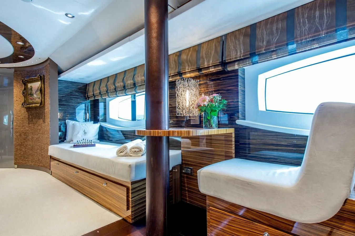 a room with a bed and a chair aboard TIAMAT Yacht for Sale