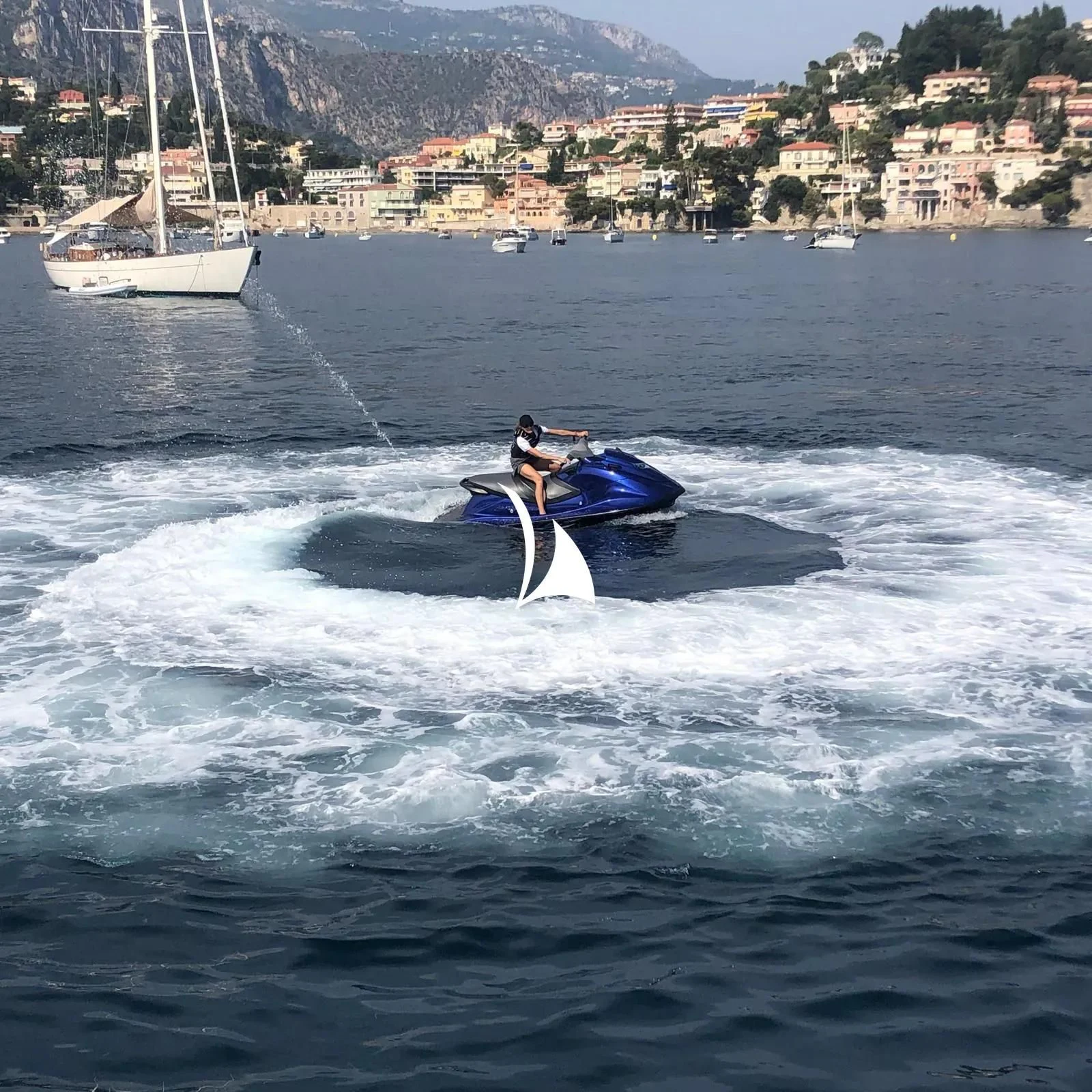a couple of people on surfboards in the water aboard TIAMAT Yacht for Sale
