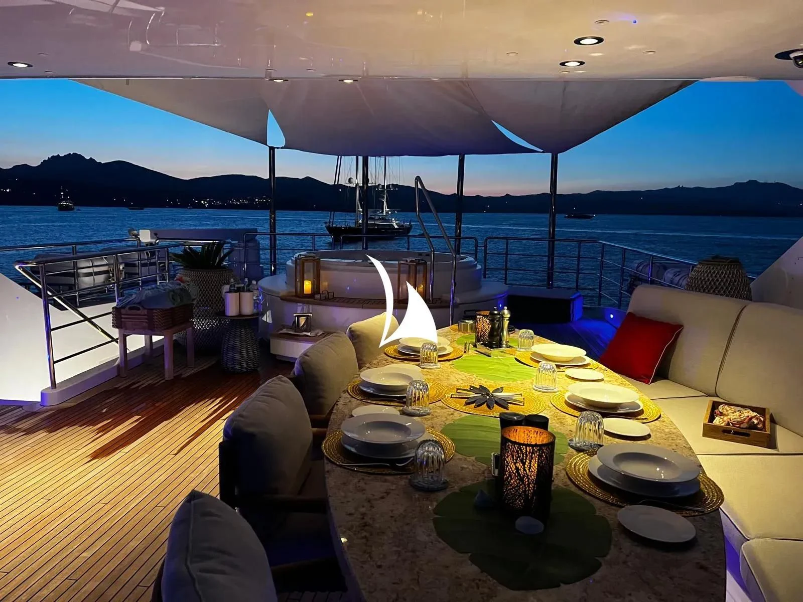 a large table with plates and food on it aboard TIAMAT Yacht for Sale