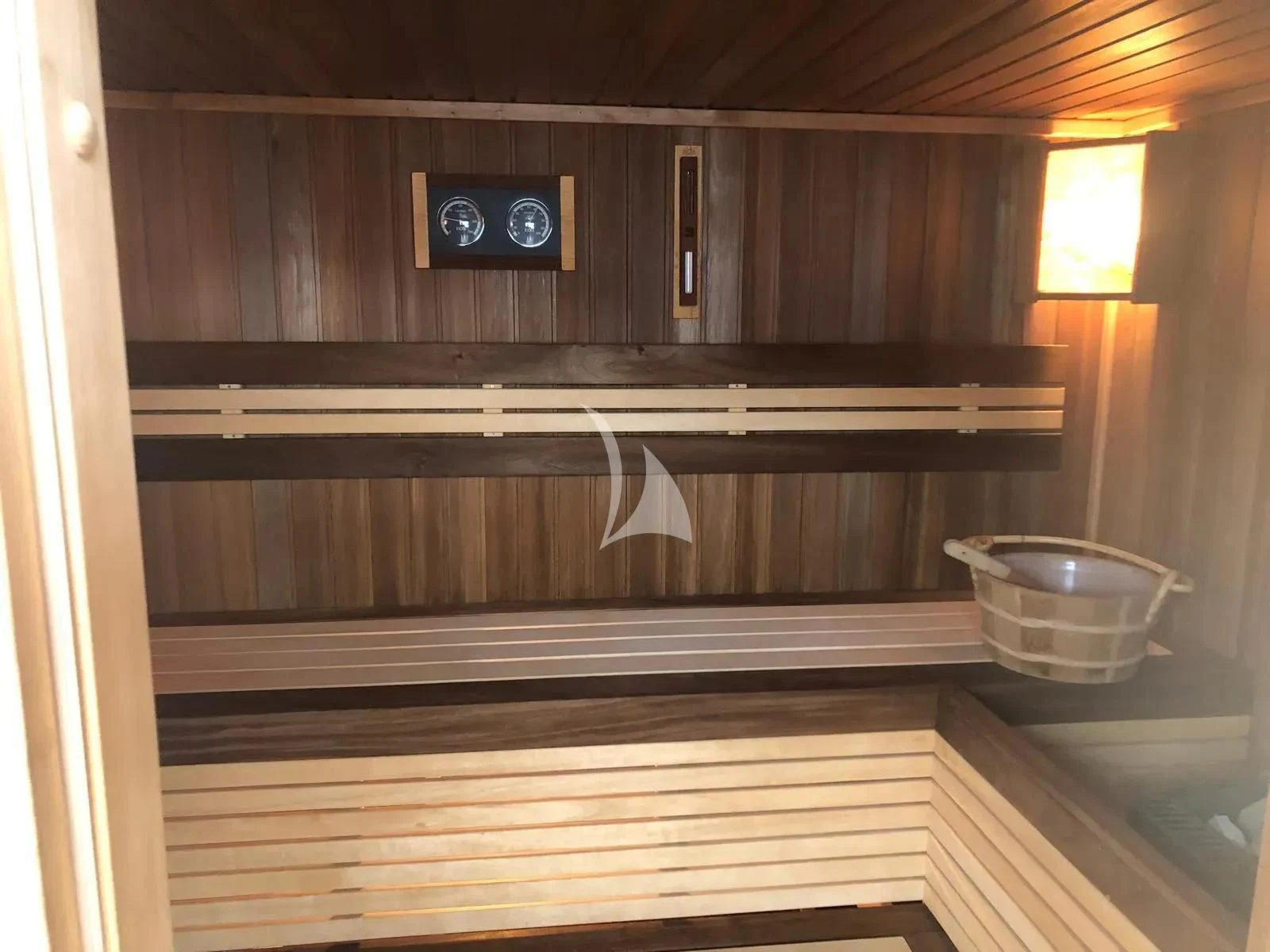 a wooden cabinet with a sink aboard TIAMAT Yacht for Sale