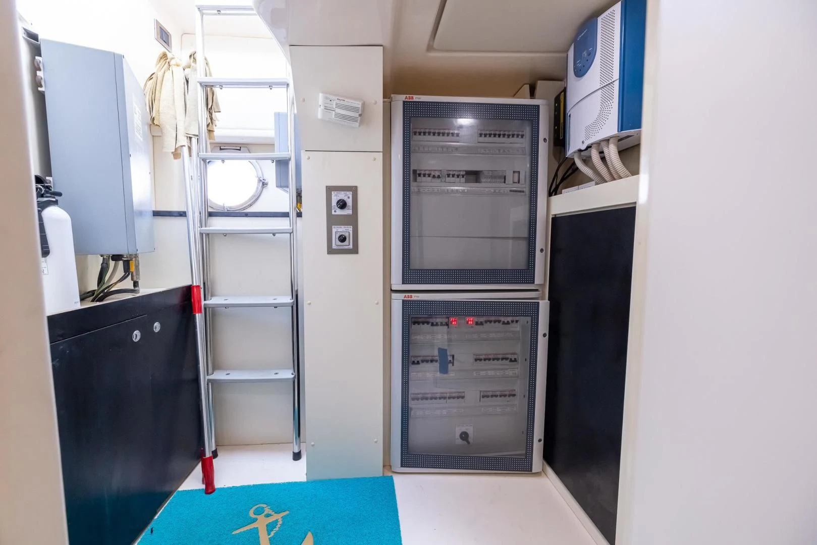 a room with a ladder and a shelf with lockers aboard MEANT TO BE Yacht for Sale