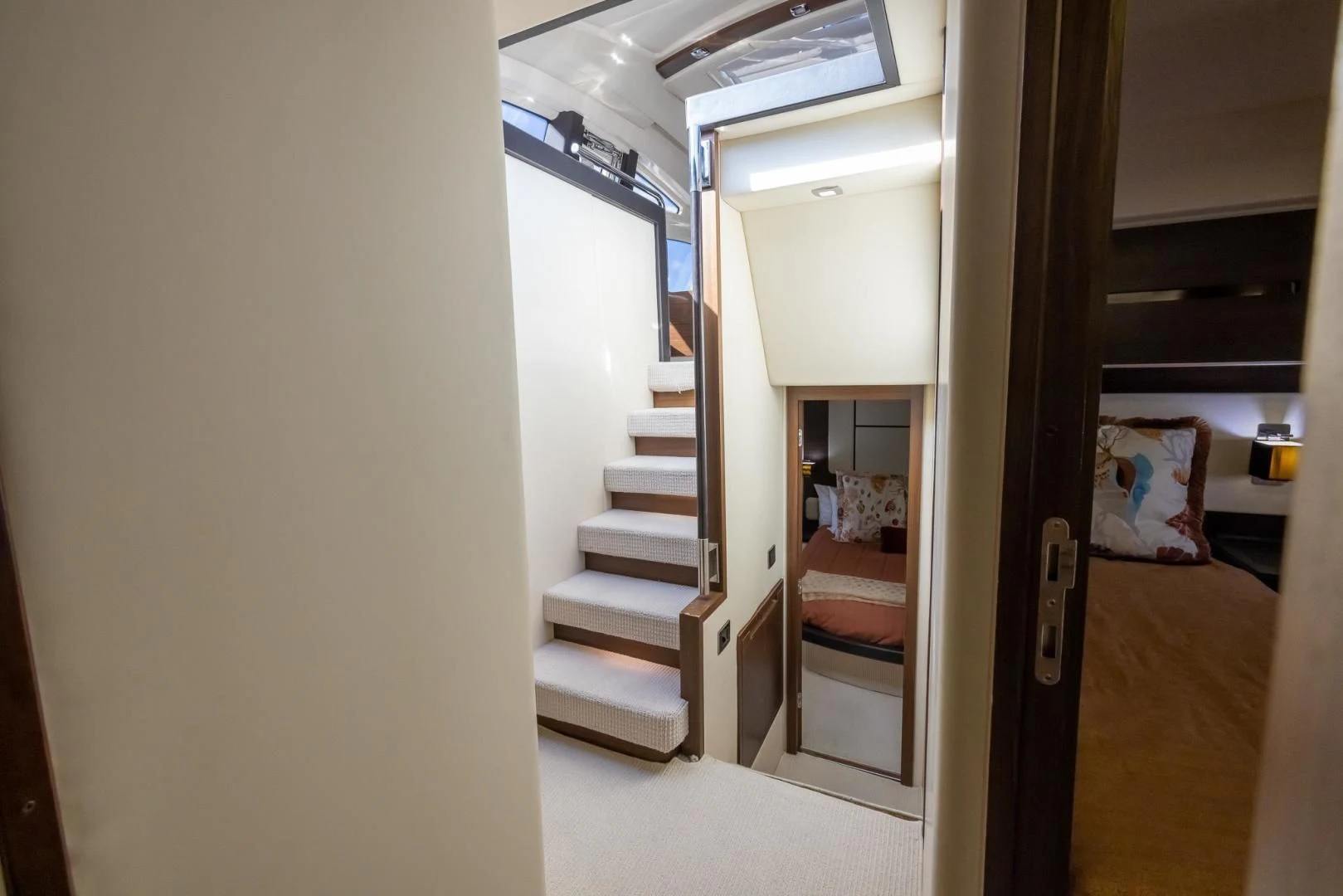 a hallway with a door and a bed aboard MEANT TO BE Yacht for Sale