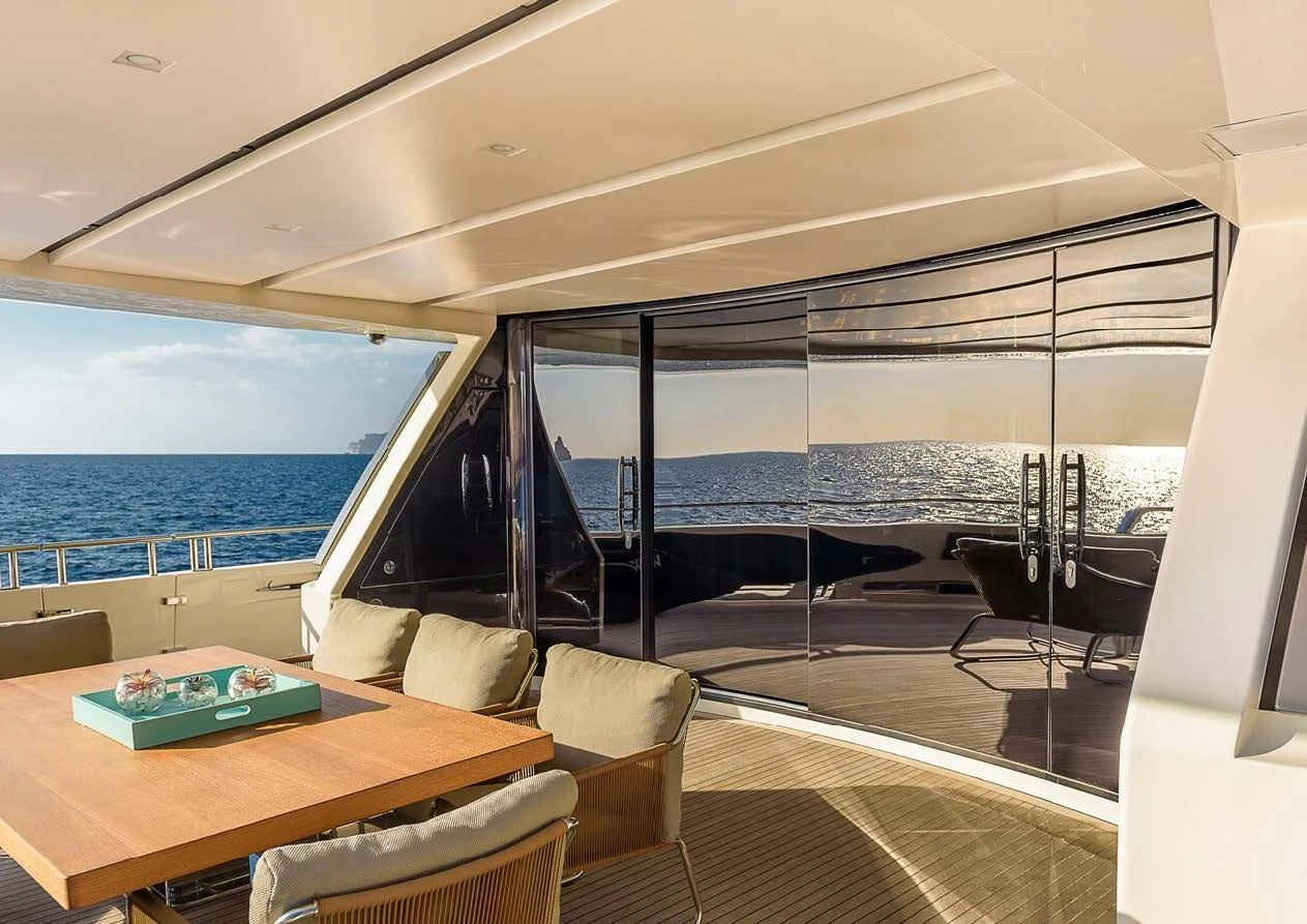 a room with a table and chairs aboard MUSHA Yacht for Sale