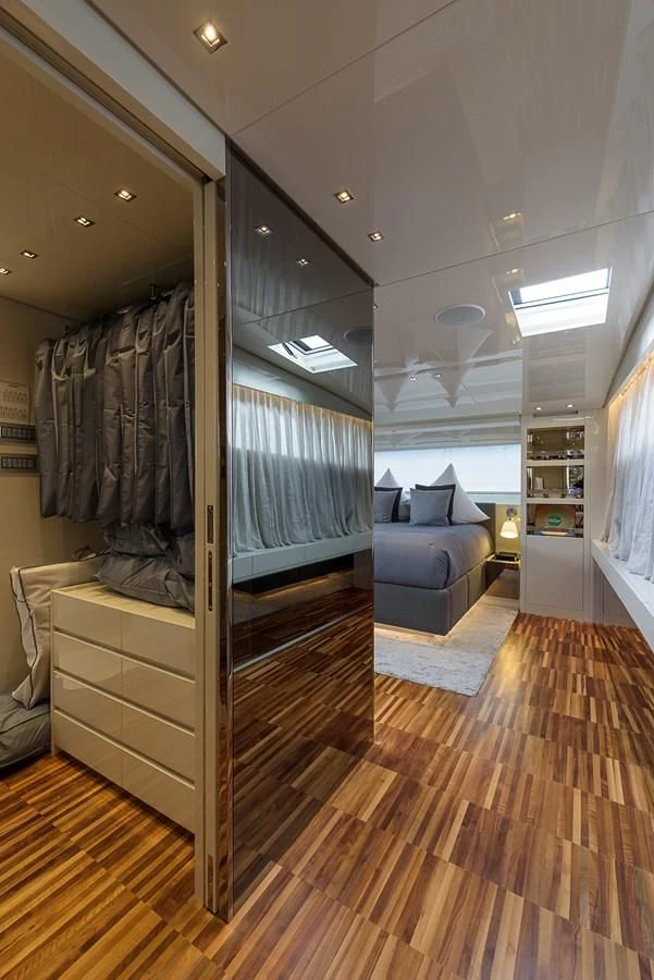 a room with a large mirror and a wood floor aboard MUSHA Yacht for Sale