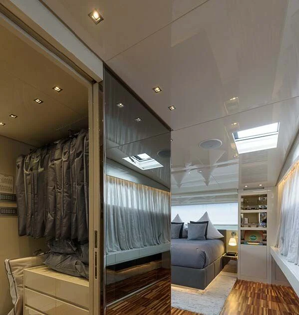 a room with a blue couch and a large mirror aboard MUSHA Yacht for Sale